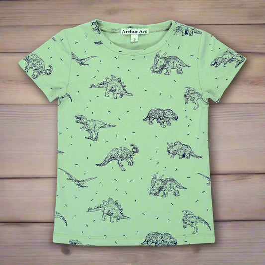 From the Byron Bay Collection by Arthur Ave a t-shirt featuring all sorts of dinosaurs. Printed in dark navy on a sage background this striking tee is perfect for any dino fanatic!! With a crew neck and short sleeves this will be a summer fave. Add a long sleeve top underneath for the winter!!