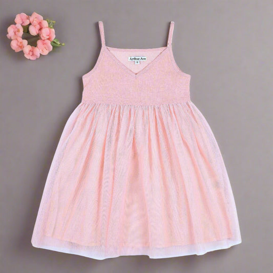 From the London Pink Collection by Arthur Ave the Tulle Babydoll Dress is the ultimate dress for the summer. A vee neck slip on dress with adjustable straps. If your little girl loves to dance, spin & twirl this is will be one of her favorites this summer whatever the occasion. Made from hemp, viscose & cotton, perfect for those hot days!