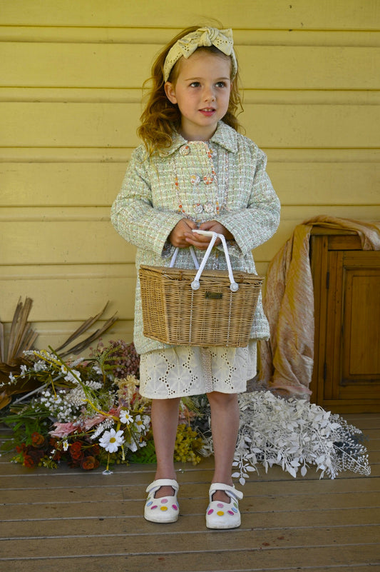 This adorable vintage inspired coat is from Arthur Ave's Winter Bloom Collection. In a mint tweed with gold thread running through on the outside, it is fully lined inside in an autumn toned floral pattern fabric. Completing the style is the double-breasted front which can be buttoned to either side with four gorgeous floral fabric covered buttons.