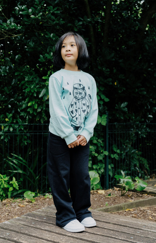 The Mishka Cat Crew by The Girl Club is not only cute it’s a beautiful illustration of their team pet. Crafted from soft fleece cotton, this cosy crew features a bold ‘Mishka’ graphic on the front and subtle bell sleeves finished with ribbed cuffs for a soft touch. Pair it with the Ruby Winter Leggings. Designed in New Zealand and ethically made by their friends in Bangladesh.