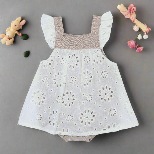 PRODUCT DESCRIPTION From the Neutral Love Collection by Arthur Ave this mid-taupe colour playsuit has a white broderie anglaise overlay, tucks across the chest, gathered cap sleeves and is utterly adorable! Buttons down the back, domes at the crutch and elasticated leg holes make it easy to dress your little one. We love it and so will you! MATERIALS 100% Cotton CARE INSTRUCTIONS Please read garment labels