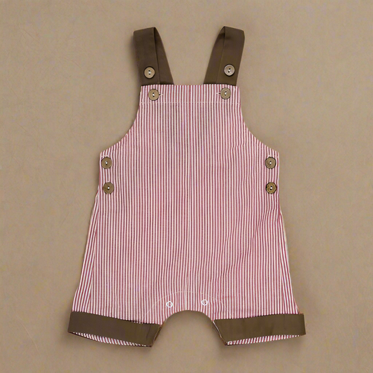 PRODUCT DESCRIPTION
These cute all-in-one overalls are ideal for wearing on their own or layering if it's a little cooler. The leg finishes on mid-thigh. Adjustable button shoulder straps and press studs for crotch opening help with ease of dressing. In red and white stripes with a contrasting brown shoulder straps and pant cuffs have an almost Christmas appearance.
MATERIALS
100% Cotton
CARE AND SAFETY INSTRUCTIONS
Please read all product labels. Low fire risk. Keep away from heat and flame.