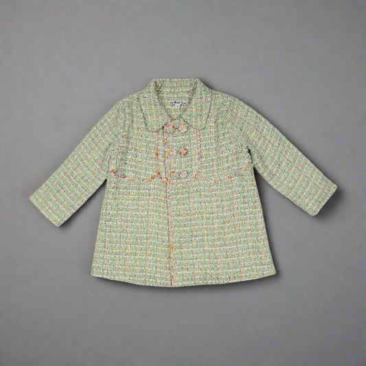 This adorable vintage inspired coat is from Arthur Ave's Winter Bloom Collection. In a mint tweed with gold thread running through on the outside, it is fully lined inside in an autumn toned floral pattern fabric. Completing the style is the double-breasted front which can be buttoned to either side with four gorgeous floral fabric covered buttons.